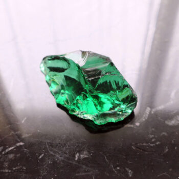 Black table with green crystal glass