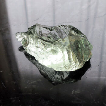 Black table with light green crystal glass