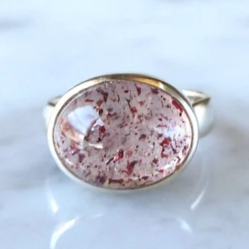 Close-up of crystal ring with red pattern