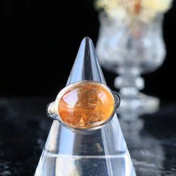 Ring with orange stone on ring holder