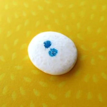 White loose with two blue patterns on yellow background